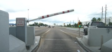 A toll booth arm swings upward