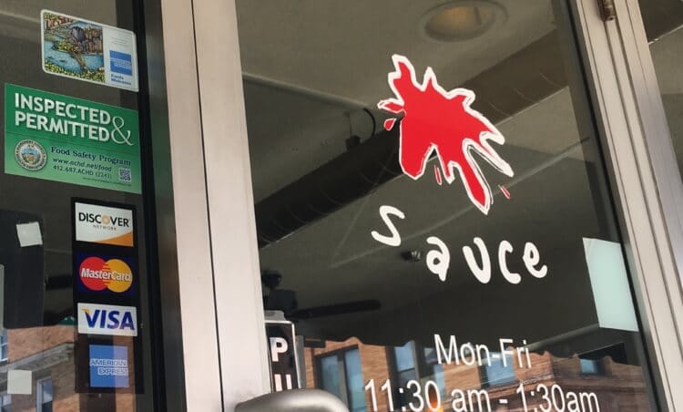 The front window and door of Sauce restaurant in Bridgeville.